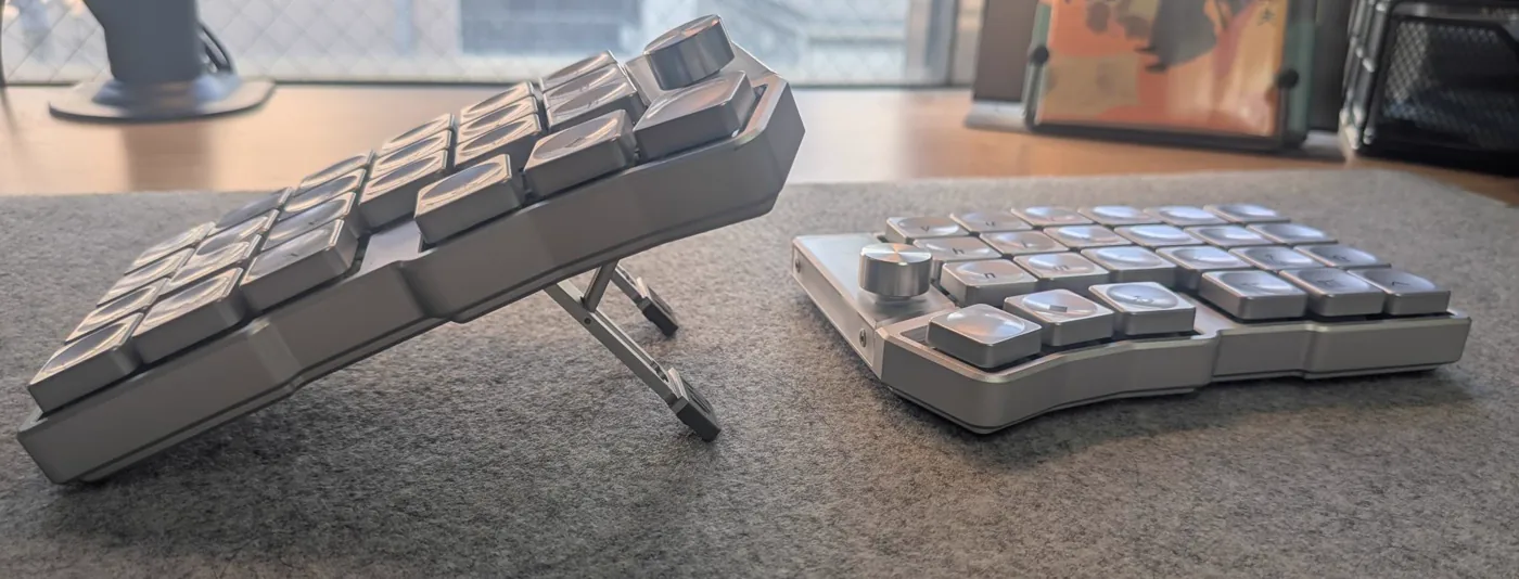 Side-on view of the keyboard, the left half raised steeply on its fold-out strut and the right half sitting flat